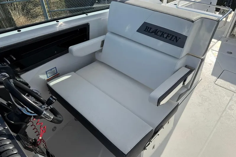  Yacht Photos Pics 2019 Blackfin 272 DC boat interior with steering wheel and cushioned seating.