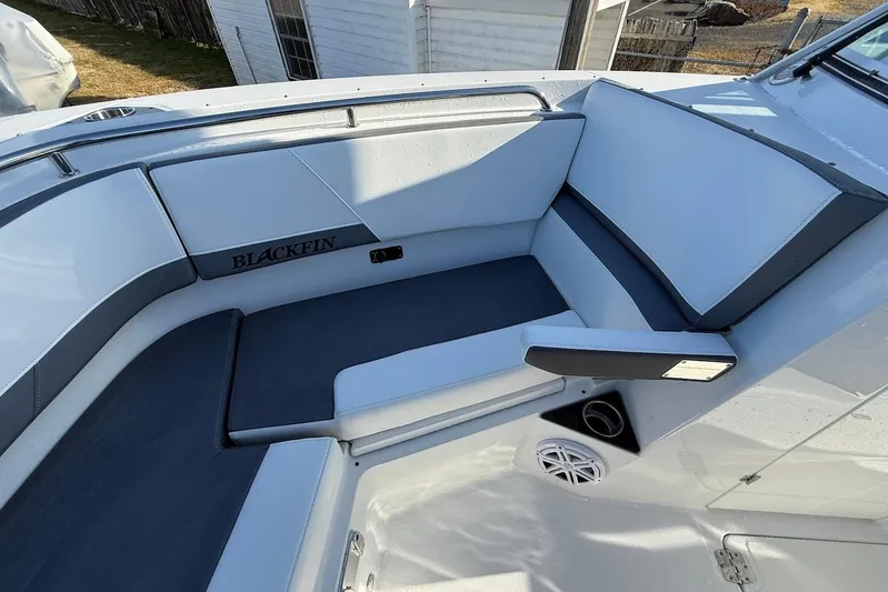  Yacht Photos Pics 2019 Blackfin 272 DC boat interior with cushioned seating and speaker.