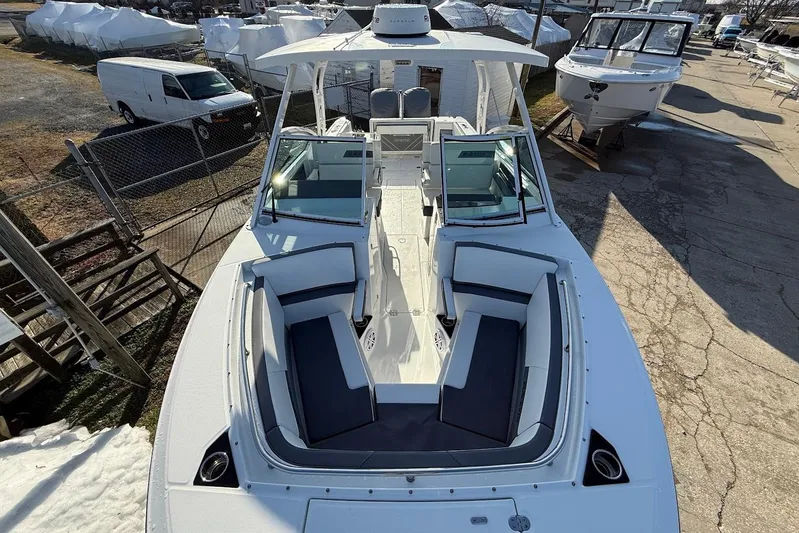  Yacht Photos Pics 2019 Blackfin 272 DC boat with spacious seating, docked in a marina.