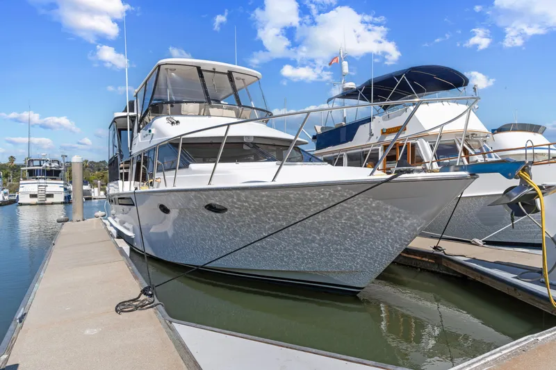 One Moor Day Yacht Photos Pics Ocean Alexander 440 yacht, 1993 model, docked at marina under blue sky.