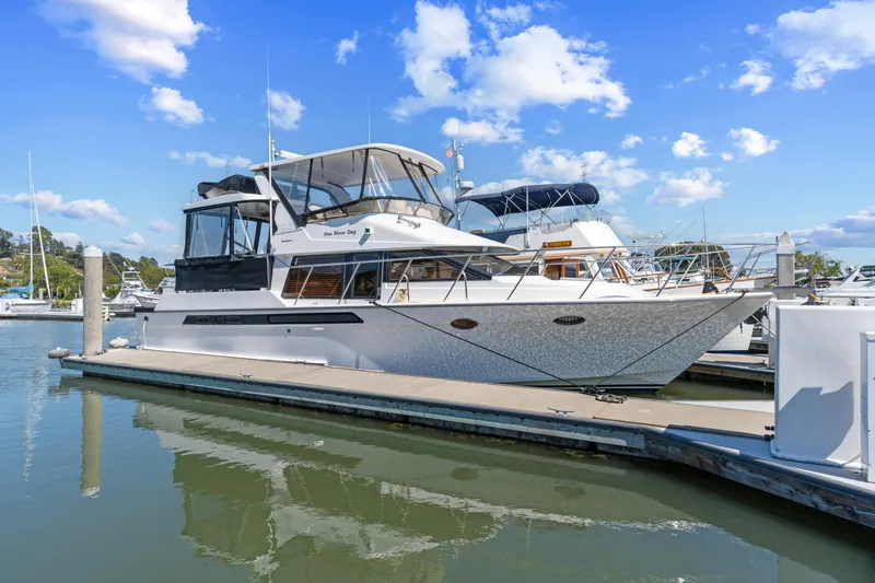 One Moor Day Yacht Photos Pics 1993 Ocean Alexander 440 yacht docked at marina under blue sky.