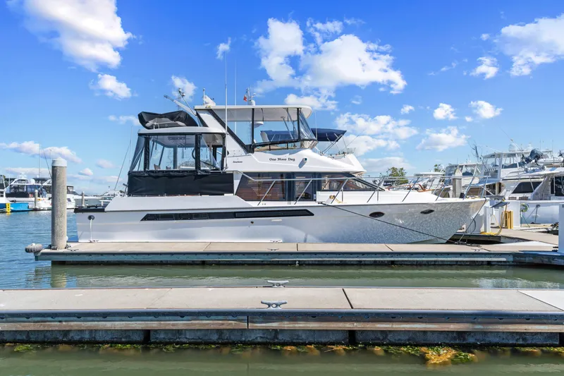 One Moor Day Yacht Photos Pics 1993 Ocean Alexander 440 yacht docked at marina under blue sky.
