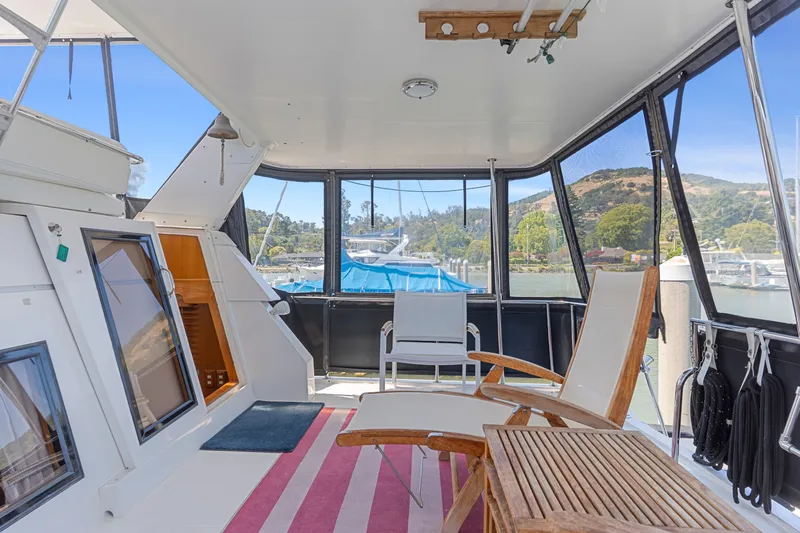 One Moor Day Yacht Photos Pics 1993 Ocean Alexander 440 yacht interior with seating, table, and scenic marina view.