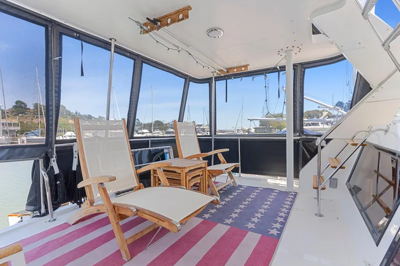 One Moor Day Yacht Photos Pics Spacious deck of 1993 Ocean Alexander 440 yacht with chairs and American flag rug.