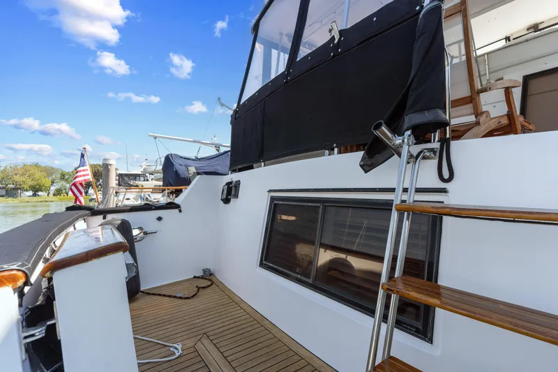 One Moor Day Yacht Photos Pics 1993 Ocean Alexander 440 yacht deck with wooden steps and American flag.