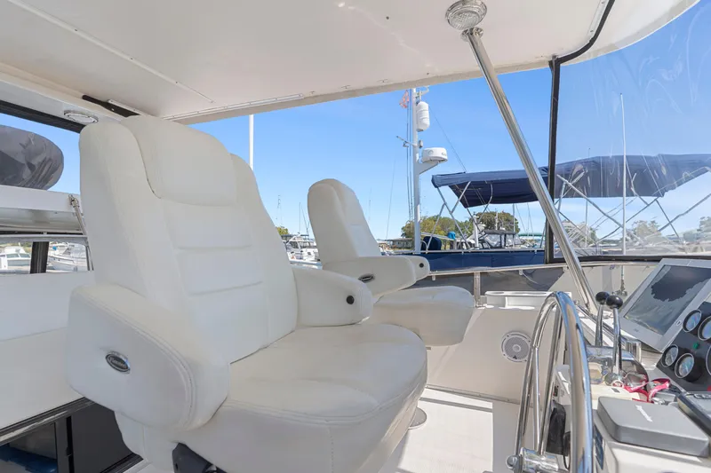 One Moor Day Yacht Photos Pics Luxury helm seats on 1993 Ocean Alexander 440 yacht, featuring modern navigation equipment.