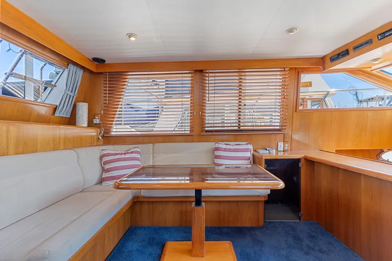 One Moor Day Yacht Photos Pics Interior of 1993 Ocean Alexander 440 yacht with wooden accents and cozy seating area.