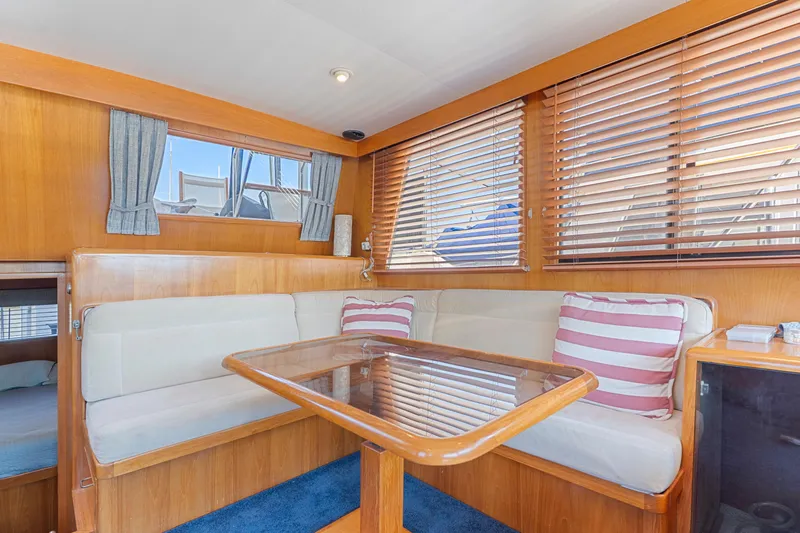 One Moor Day Yacht Photos Pics Interior of 1993 Ocean Alexander 440 yacht with cozy dining area and striped cushions.