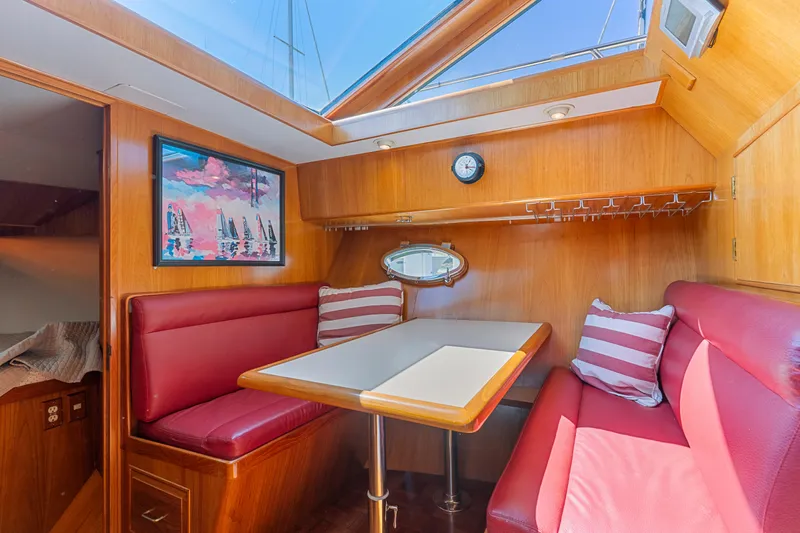 One Moor Day Yacht Photos Pics Luxurious 1993 Ocean Alexander 440 yacht interior with red seating and skylight.