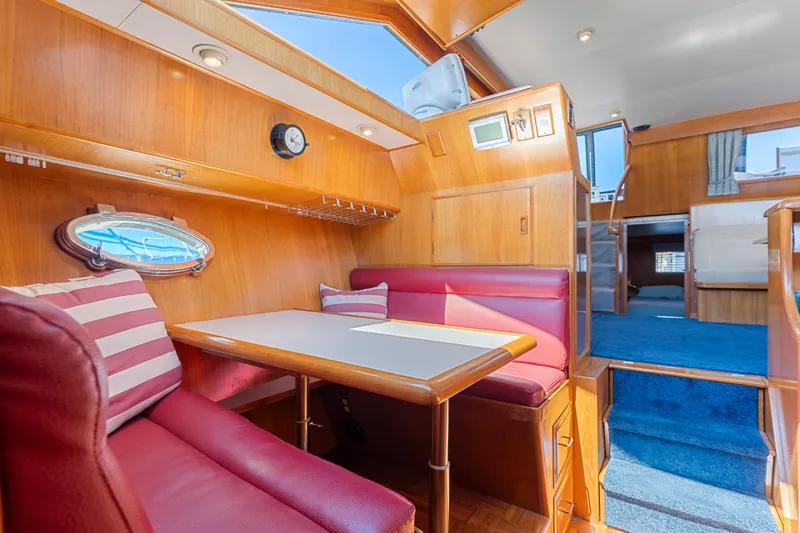 One Moor Day Yacht Photos Pics Interior of 1993 Ocean Alexander 440 yacht with cozy dining area and wooden finishes.