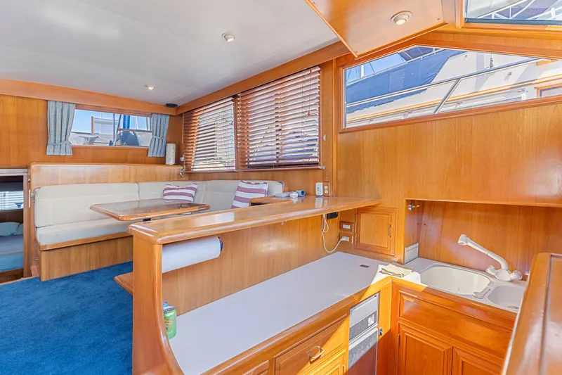 One Moor Day Yacht Photos Pics Luxurious 1993 Ocean Alexander 440 yacht interior with wood finish and cozy seating area.