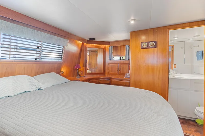 One Moor Day Yacht Photos Pics Luxurious 1993 Ocean Alexander 440 yacht bedroom with wood paneling and ensuite bathroom.