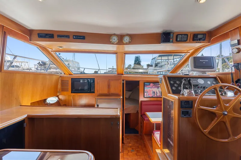 One Moor Day Yacht Photos Pics Interior of 1993 Ocean Alexander 440 yacht with wooden helm and navigation equipment.