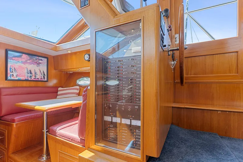 One Moor Day Yacht Photos Pics 1993 Ocean Alexander 440 yacht interior with wood paneling and red seating.
