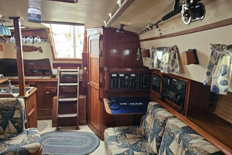 Water Dance Yacht Photos Pics Interior of a 1999 Island Packet 350 sailboat with cozy seating and nautical decor.