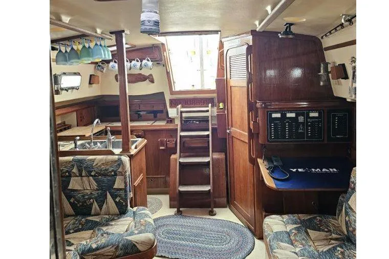 Water Dance Yacht Photos Pics Interior of 1999 Island Packet 350 sailboat with nautical-themed decor and wooden finishes.