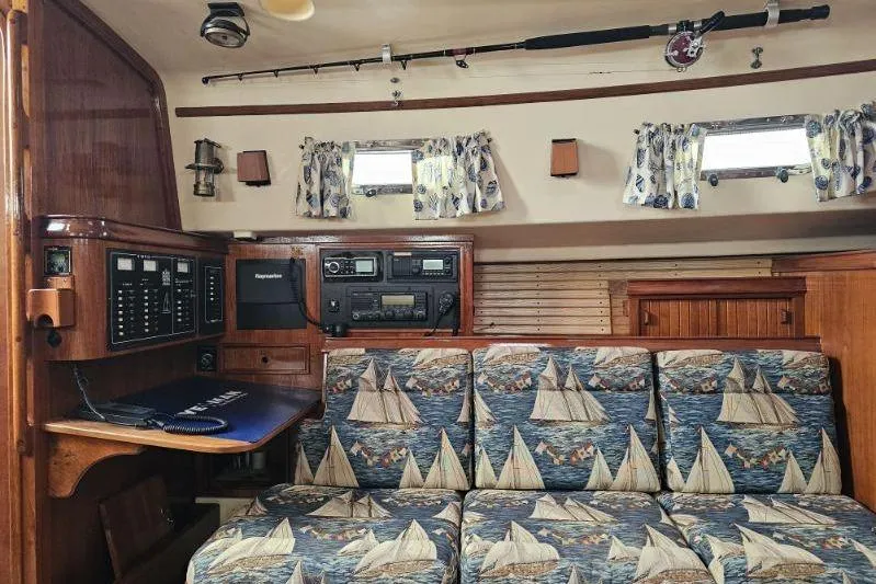 Water Dance Yacht Photos Pics 1999 Island Packet 350 yacht interior with nautical-themed upholstery and navigation equipment.