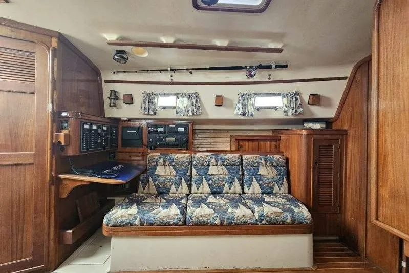 Water Dance Yacht Photos Pics Interior of 1999 Island Packet 350 sailboat with nautical-themed upholstery and wooden cabinetry.