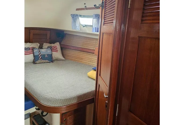 Water Dance Yacht Photos Pics Cozy cabin interior of 1999 Island Packet 350 sailboat with wooden finish and nautical decor.