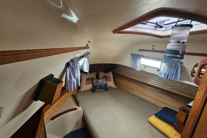 Water Dance Yacht Photos Pics 1999 Island Packet 350 cabin interior with cozy bedding and nautical decor.