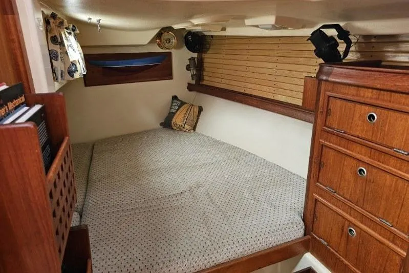 Water Dance Yacht Photos Pics Cozy cabin interior of 1999 Island Packet 350 sailboat with wooden cabinetry and bedding.