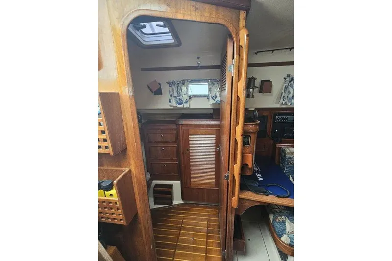 Water Dance Yacht Photos Pics Interior of 1999 Island Packet 350 sailboat with wooden cabinetry and nautical decor.