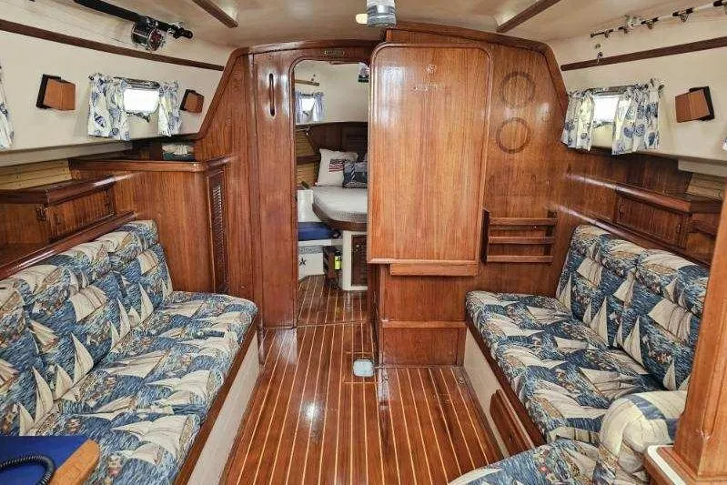 Water Dance Yacht Photos Pics 1999 Island Packet 350 sailboat interior with wood finish and patterned seating.