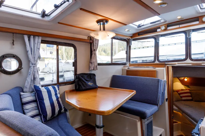  Yacht Photos Pics Interior of 2010 Ranger Tugs R-29 Sedan Luxury Edition with cozy seating and dining area.