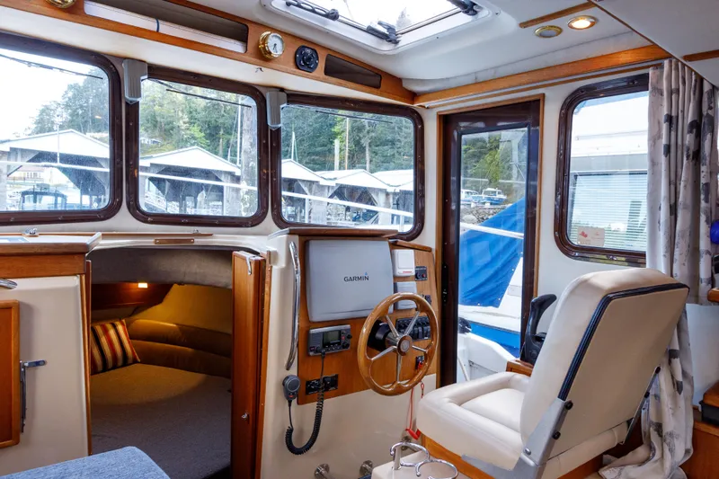  Yacht Photos Pics Interior of 2010 Ranger Tugs R-29 Sedan Luxury Edition, featuring helm and seating area.