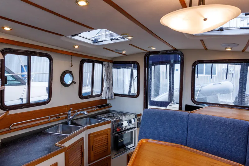  Yacht Photos Pics Interior of 2010 Ranger Tugs R-29 Sedan Luxury Edition with kitchen and seating area.