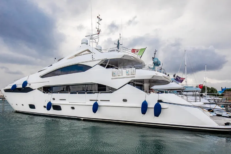  Yacht Photos Pics Luxurious 2014 Sunseeker 40 Metre Yacht docked in a marina under cloudy skies.