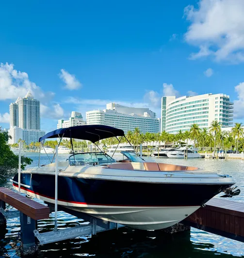  Yacht Photos Pics 2015 Chris-Craft Launch 32 boat docked with city skyline and palm trees in the background.