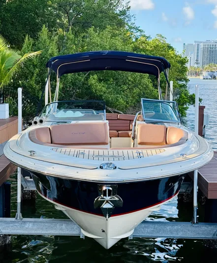  Yacht Photos Pics 2015 Chris-Craft Launch 32 boat docked by lush greenery.