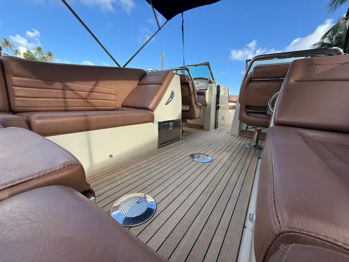  Yacht Photos Pics 2015 Chris-Craft Launch 32 interior with brown leather seats and teak flooring under blue sky.