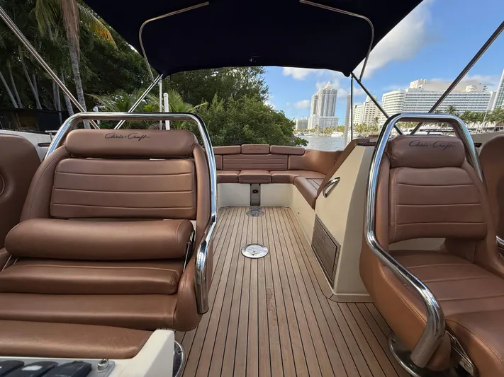  Yacht Photos Pics 2015 Chris-Craft Launch 32 interior with brown leather seats and wooden deck.