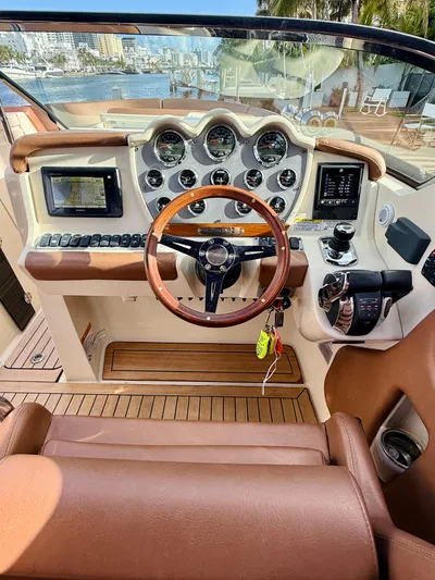  Yacht Photos Pics 2015 Chris-Craft Launch 32 dashboard with wooden steering wheel and modern controls.