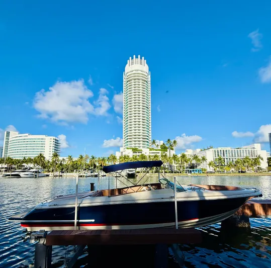  Yacht Photos Pics 2015 Chris-Craft Launch 32 boat docked with a cityscape backdrop.