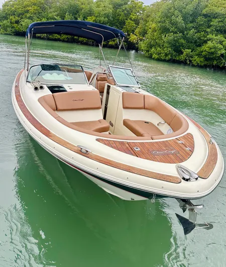  Yacht Photos Pics 2015 Chris-Craft Launch 32 boat with tan seating, docked on calm water.