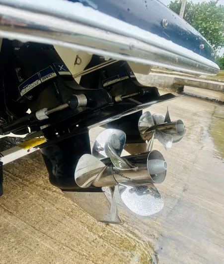  Yacht Photos Pics 2015 Chris-Craft Launch 32 boat propellers, close-up view, on a wet dock surface.