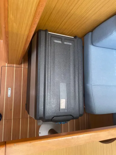 Kindred Spirit Yacht Photos Pics Black suitcase on Jeanneau Sun Odyssey 45 DS yacht, 2008 model, wooden interior, blue seating.