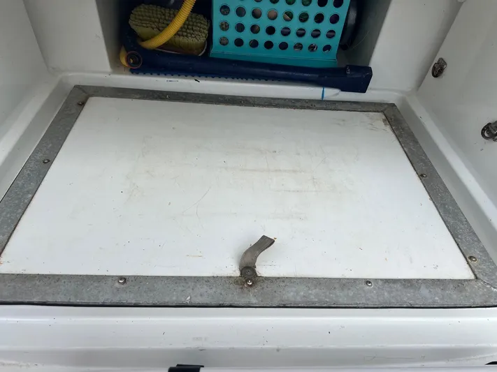 Kindred Spirit Yacht Photos Pics Storage compartment on a 2008 Jeanneau Sun Odyssey 45 DS sailboat, featuring cleaning supplies.