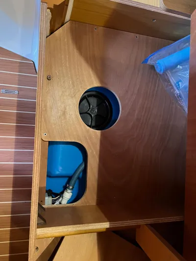 Kindred Spirit Yacht Photos Pics Interior view of 2008 Jeanneau Sun Odyssey 45 DS yacht, showcasing storage compartment and blue tank.