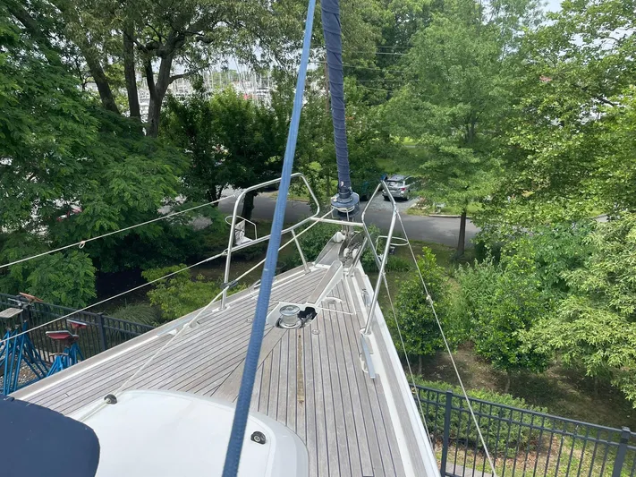 Kindred Spirit Yacht Photos Pics 2008 Jeanneau Sun Odyssey 45 DS sailboat deck with lush greenery background.