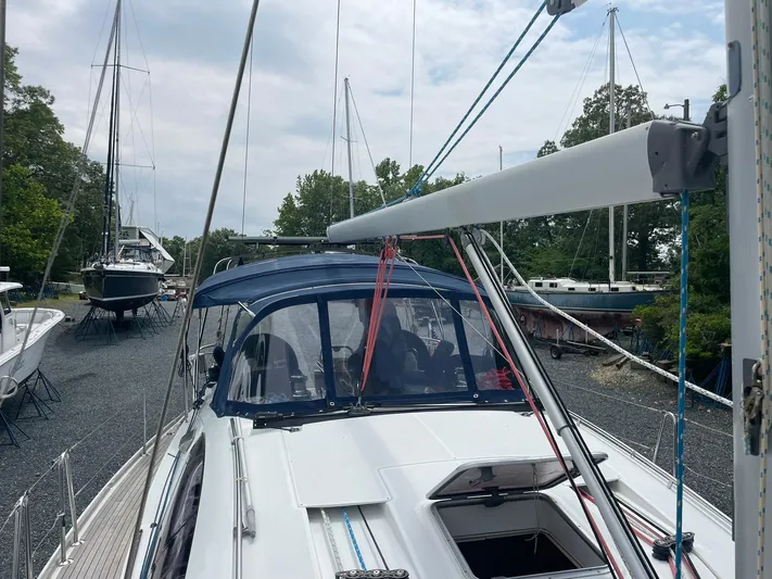 Kindred Spirit Yacht Photos Pics 2008 Jeanneau Sun Odyssey 45 DS sailboat docked, featuring a blue canopy and sleek design.