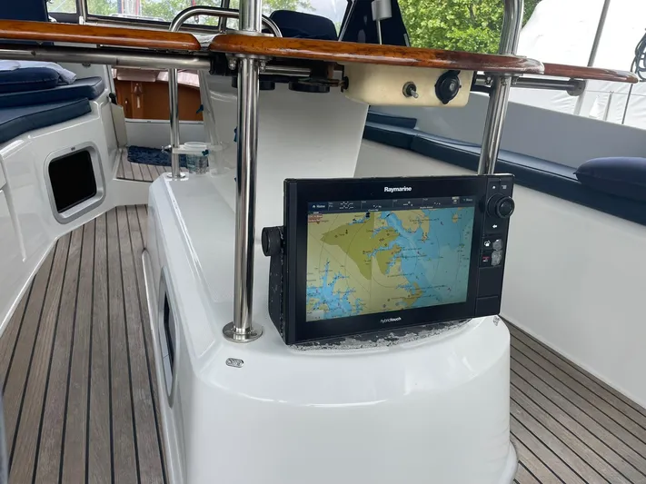 Kindred Spirit Yacht Photos Pics 2008 Jeanneau Sun Odyssey 45 DS cockpit with navigation system and wooden accents.