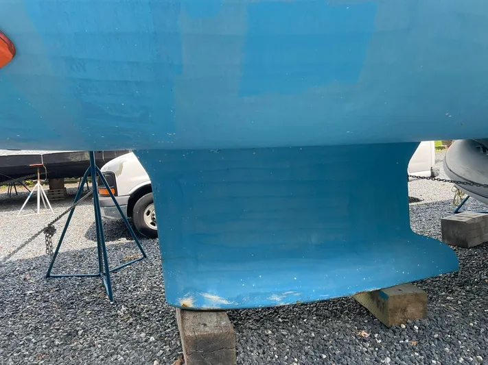 Kindred Spirit Yacht Photos Pics 2008 Jeanneau Sun Odyssey 45 DS sailboat keel on gravel, supported by blocks.