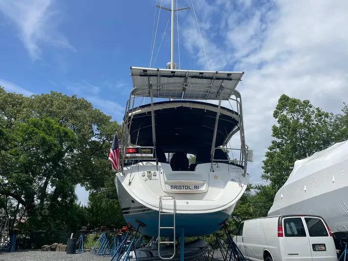 Kindred Spirit Yacht Photos Pics 2008 Jeanneau Sun Odyssey 45 DS sailboat on land, with trees and a van nearby.