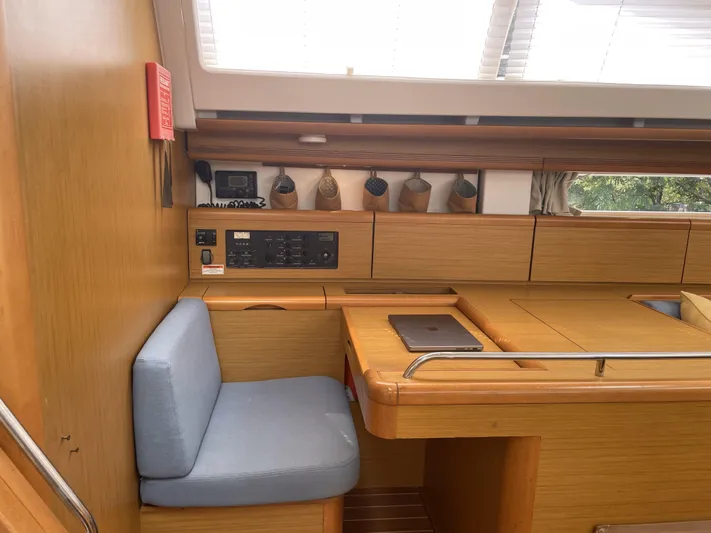 Kindred Spirit Yacht Photos Pics Interior of 2008 Jeanneau Sun Odyssey 45 DS yacht with navigation station and seating.