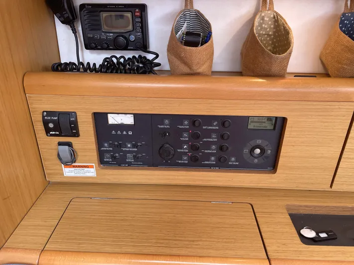 Kindred Spirit Yacht Photos Pics Control panel of 2008 Jeanneau Sun Odyssey 45 DS sailboat with radio and storage compartments.