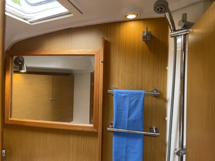Kindred Spirit Yacht Photos Pics Bathroom interior of 2008 Jeanneau Sun Odyssey 45 DS yacht with shower and mirror.